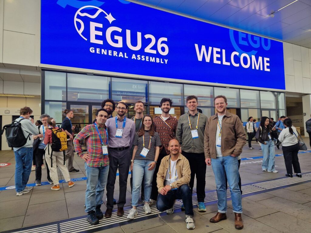 A group photo of the Fathom team outside the EGU26 conference hall in Vienna