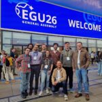 A group photo of the Fathom team outside the EGU26 conference hall in Vienna